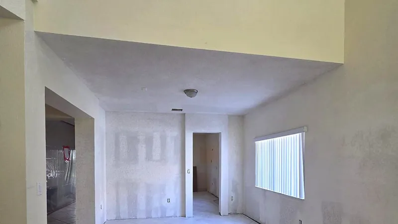 Room with patched drywall and joint compound, ready for sanding