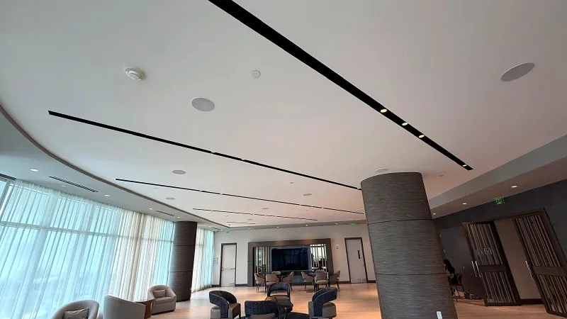 Finished lobby with a curved ceiling and linear lighting